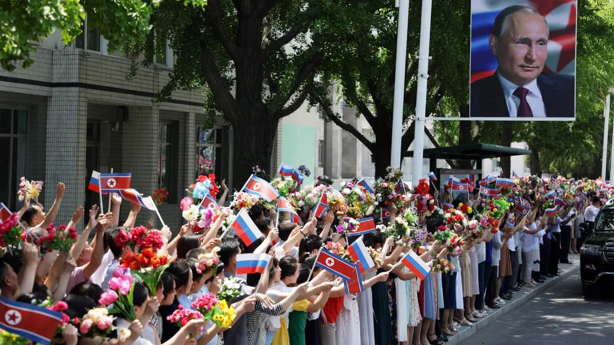 North Koreans greet a motorcade carrying Vladimir Putin and North Korean dictator Kim Jong Un through Pyongyang during the Russian leader’s brief visit to the country on 19 June 2024. Photo: EPA/GAVRIIL GRIGOROV